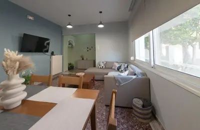 a living room with a couch and a table at Cityscape House in Chania Town