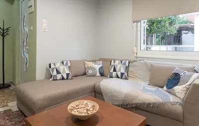 a living room with a couch and a table at Cityscape House in Chania Town