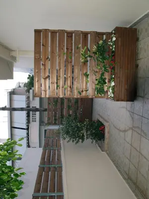a balcony with plants on the wall of a building at Urban Sea Apts in Chania Town