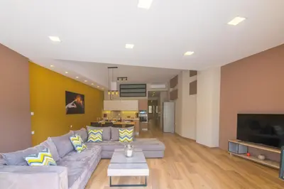 a living room with a couch and a tv at UTOPIA luxury apartment in Chania Town