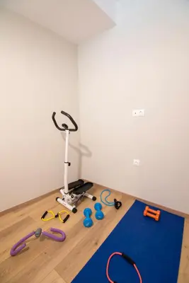 a room with a treadmill and some toys on the floor at UTOPIA luxury apartment in Chania Town