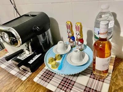 a table with a coffee maker and a bottle of syrup at Art Home in Chania Town