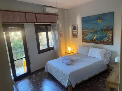 a bedroom with a bed and a painting on the wall at Art Home in Chania Town