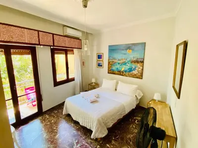 a bedroom with a bed and a painting on the wall at Art Home in Chania Town
