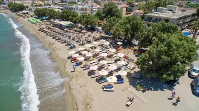 an aerial view of a beach with umbrellas and chairs at Kalyves Beach Hotel in Kalyves
