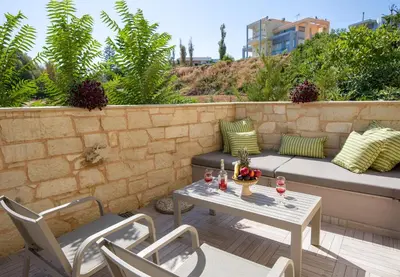 a patio with a table and chairs and a couch at Villa Sirocos in Stalos