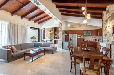 a living room with a couch and a table at Airis Boutique Hotel & Suites - For adults only in Kato Daratso