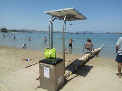 a lifeguard station on a beach with people in the water at EUPHORIA Luxury Apartment in Chania Town