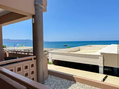 a view of the beach from the balcony of a house at Ariadne Beach in Plataniás