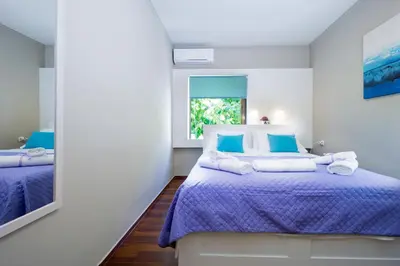 a bedroom with a bed and a mirror at Rafalia Cozy Apartment in Chania Town