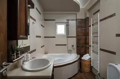 a bathroom with a tub and a sink at Villa Ira in Chorafakia