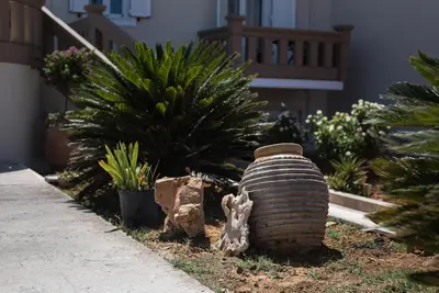 a large vase sitting on the side of a garden at Villa Ira in Chorafakia