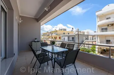 a balcony with a table and chairs on a balcony at Elegant 2BR Apartment in Chania Town
