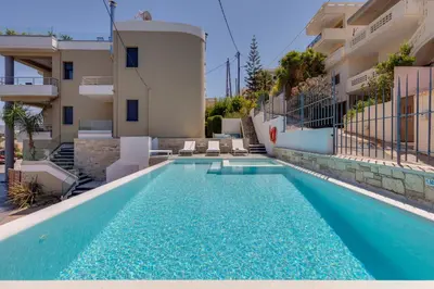 a swimming pool in front of a building at The Hill House Villa in Kato Daratso