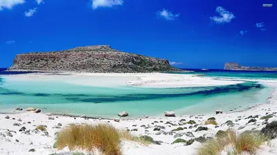 a beach with a small island in the water at You and Me -750m from the sea in Kissamos