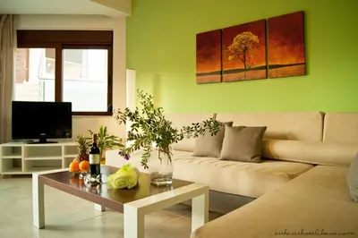 a living room with a couch and a table at Esthisis Suites Chania in Plataniás