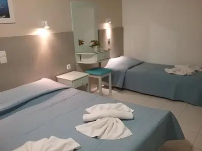 a hotel room with two beds with towels on them at Ilona Apartments Chania in Kato Daratso