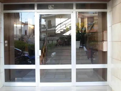 a sliding glass door in front of a building at Michele's Flat in Chania Town