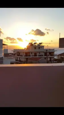 a building with the sunset in the background at Amazing Sea View Apartment in Chania Town