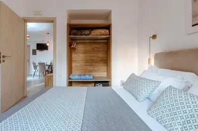 a bedroom with a large bed and a walk in closet at Deluxe Hotel in Chania Town