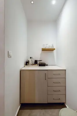 a small kitchen with a counter and a cabinet at Deluxe Hotel in Chania Town