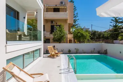 a villa with a swimming pool and a house at Villa Amelia I Free 8 seater mini van & pool in Kalathas