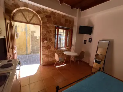 a kitchen with a table and chairs in a room at Katerina Traditional Rooms in Chania Town