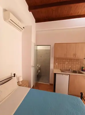 a kitchen with a blue bed in a room at Katerina Traditional Rooms in Chania Town