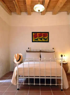 a bedroom with a bed and a wooden ceiling at Villa Irini - Authentic Cretan Retreat with Private Pool in Vafés