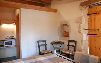 a kitchen with a table and chairs in a room at Villa Irini - Authentic Cretan Retreat with Private Pool in Vafés