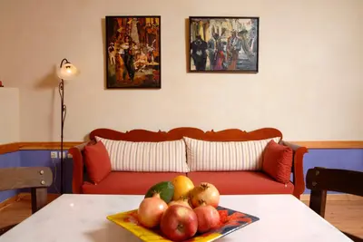 a living room with a couch and a table with fruit at Villa Irini - Authentic Cretan Retreat with Private Pool in Vafés