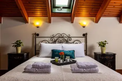 a bedroom with a bed with two pillows at Vilelmine in Chania Town