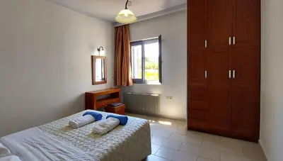 a bedroom with a bed with two towels on it at Thealia in Karefilianá