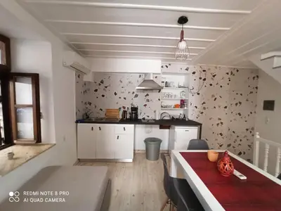 a kitchen with a red table in a room at Casa Topane in Chania Town