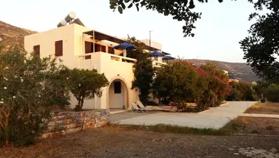 a large white house with a driveway in front of it at Doma Apartments in Falasarna