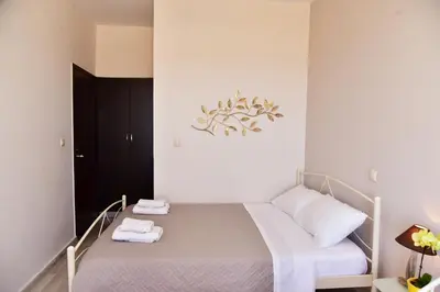 a small bedroom with a bed with towels on it at Rooms Kochilas Elafonisi in Elafonisi