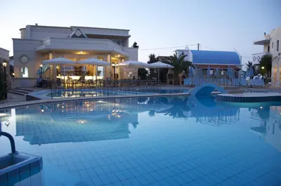 a large swimming pool in front of a hotel at Kastalia Village ,Saint Nikolas resort in Kolymvari