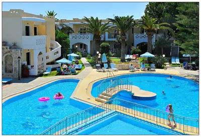a large swimming pool with people in a resort at Kastalia Village ,Saint Nikolas resort in Kolymvari