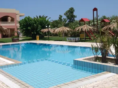 a large swimming pool in a resort at Villa Rita Apartments A in Tavronitis