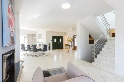 a living room with a couch and a staircase at Villa Aelia I Modern & Ideal for large groups in Galatás