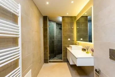 a bathroom with a sink and a shower at Villa Aelia I Modern & Ideal for large groups in Galatás