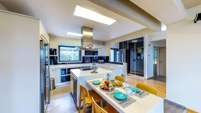 a large kitchen with a island with a counter top at Villa Veggera Chania in Kondomari