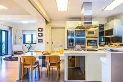 a kitchen with a table and chairs in a room at Villa Veggera Chania in Kondomari