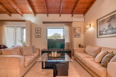 a living room with a couch and a table at Kalliopi's Maisonette in Chania Town