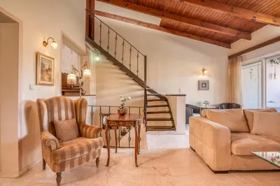 a living room with a couch and a table at Kalliopi's Maisonette in Chania Town