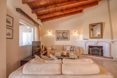 a living room with a couch and a fireplace at Kalliopi's Maisonette in Chania Town