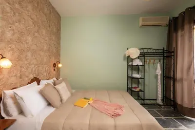 a bedroom with a bed with a book on it at Villa Georgia in Kalyves