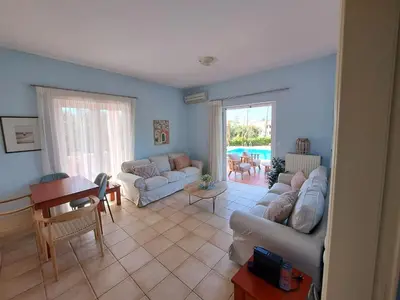 a living room with a couch and a table at Villa Armonia Chania in Kato Galatas