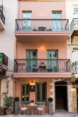 a building with chairs and a table on a balcony at The48suites in Chania Town