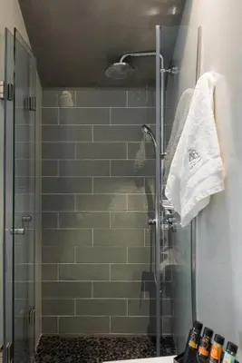 a bathroom with a shower with a glass door at The48suites in Chania Town